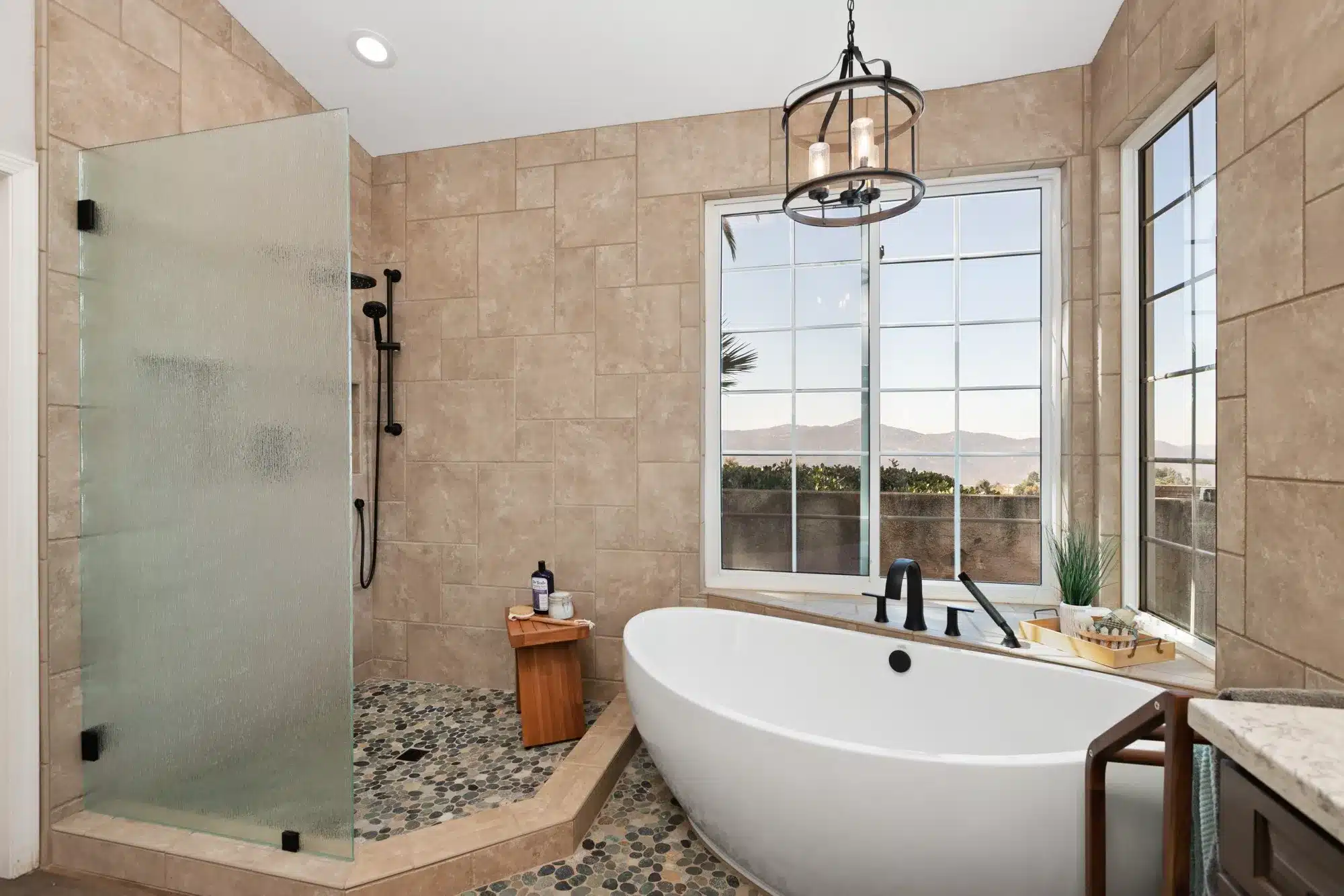 Master bathroom remodel in San Diego with freestanding soaking tub, walk-in shower, and scenic view.