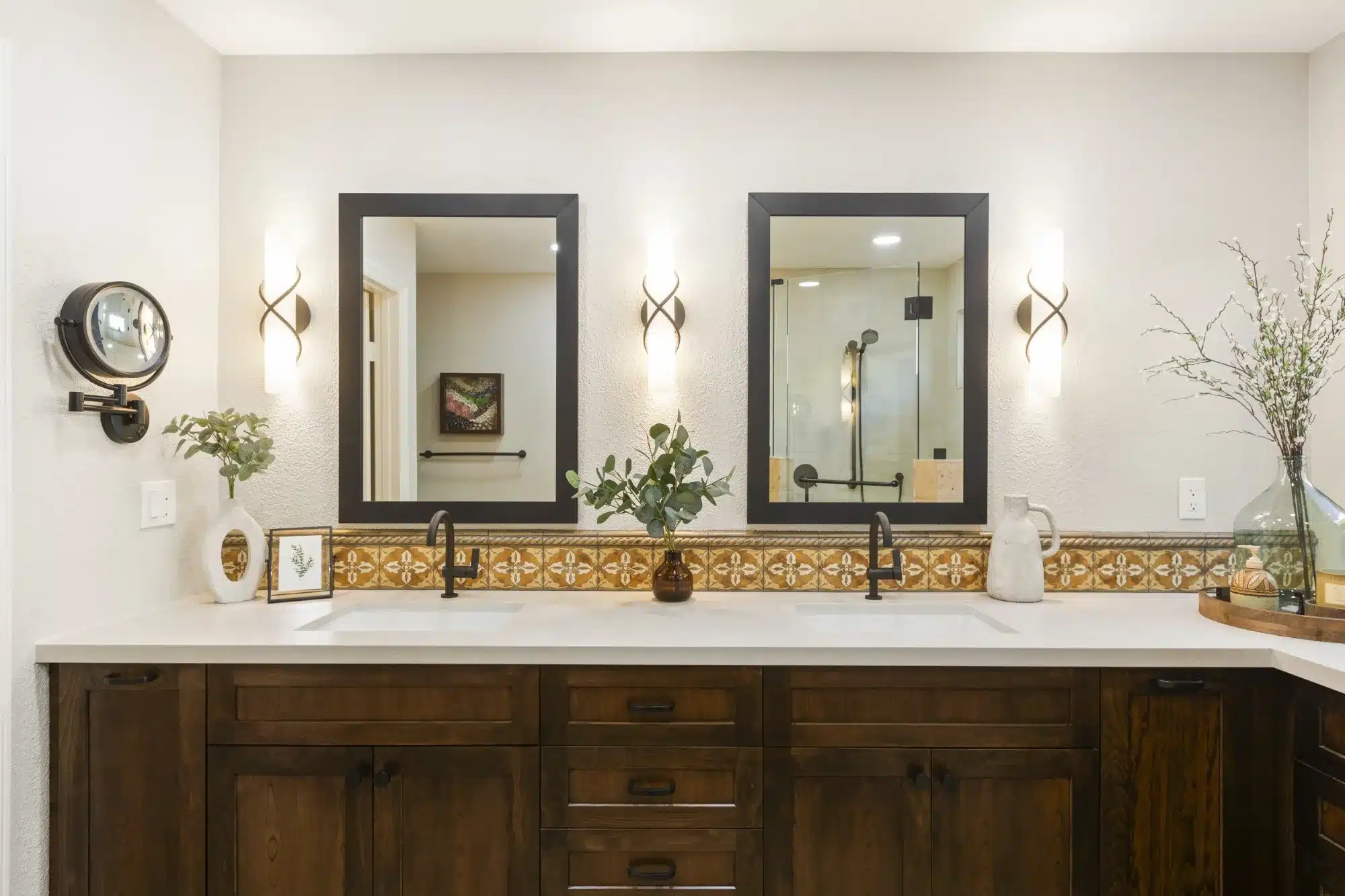 Double vanity bathroom remodel in San Diego with Spanish tile backsplash and dark wood cabinetry.